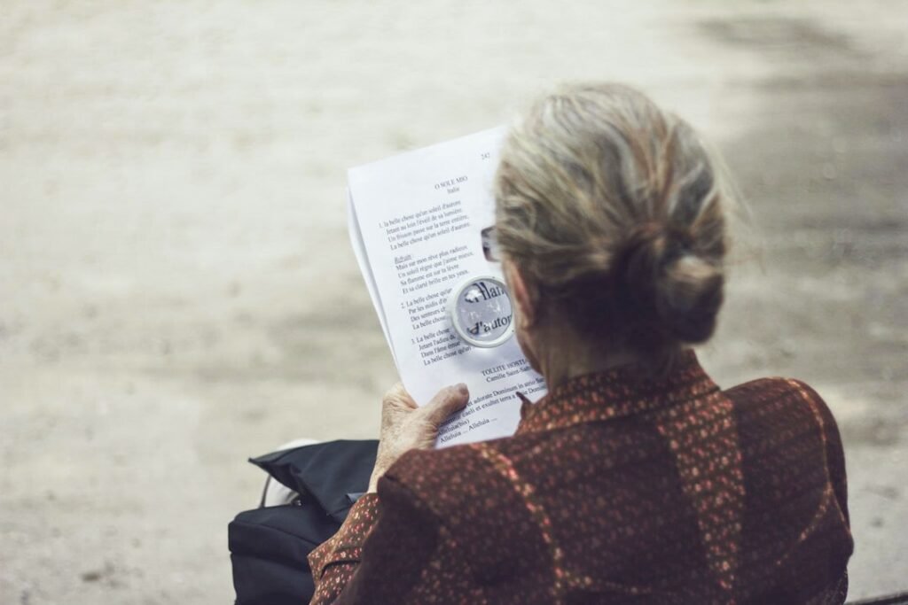 A person carefully examining printed pages of a research paper at a clean desk