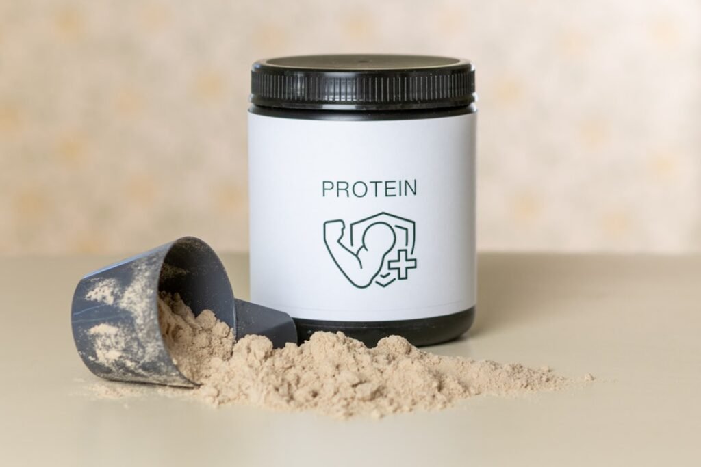 A spread of protein-rich foods including salmon, eggs, and legumes arranged on a clean wooden surface
