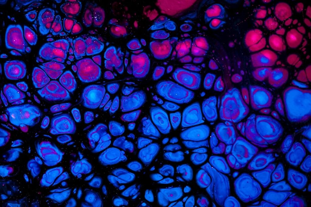 Abstract microscopic view of a single cell with fine internal structures against a dark background